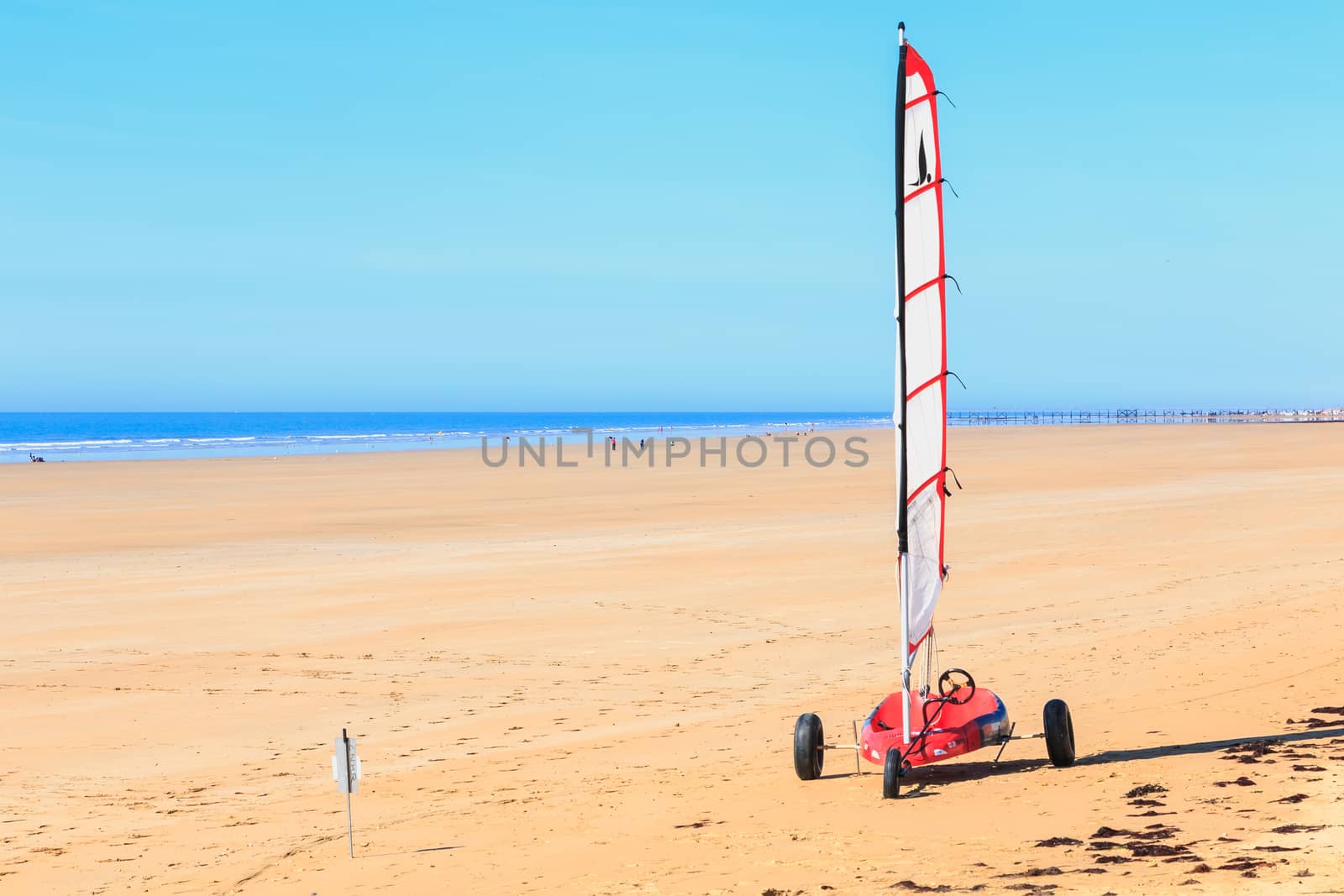 Saint Jean de Monts, France - September 23, 2017 : training sand yacht with a shuttlecock for training kids on the beach on a summer day