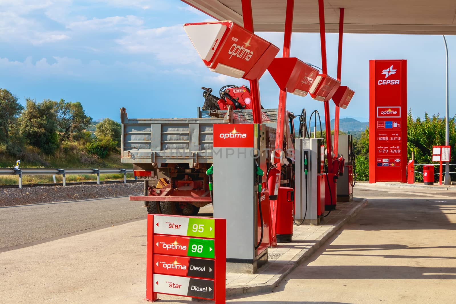 Huesca, Spain - June 21, 2017 : detail of a CEPSA gas station on a small country road with its price panels and fuel pumps at the end of the day