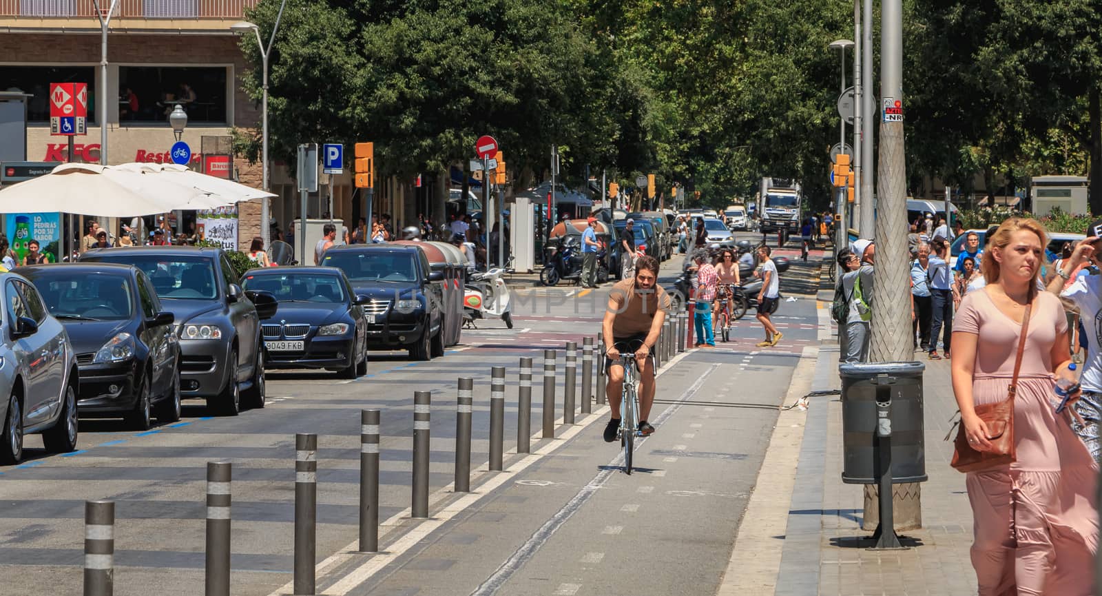 Barcelona, Spain - June 21, 2017 : cyclist riding on a bike lane on a summer day