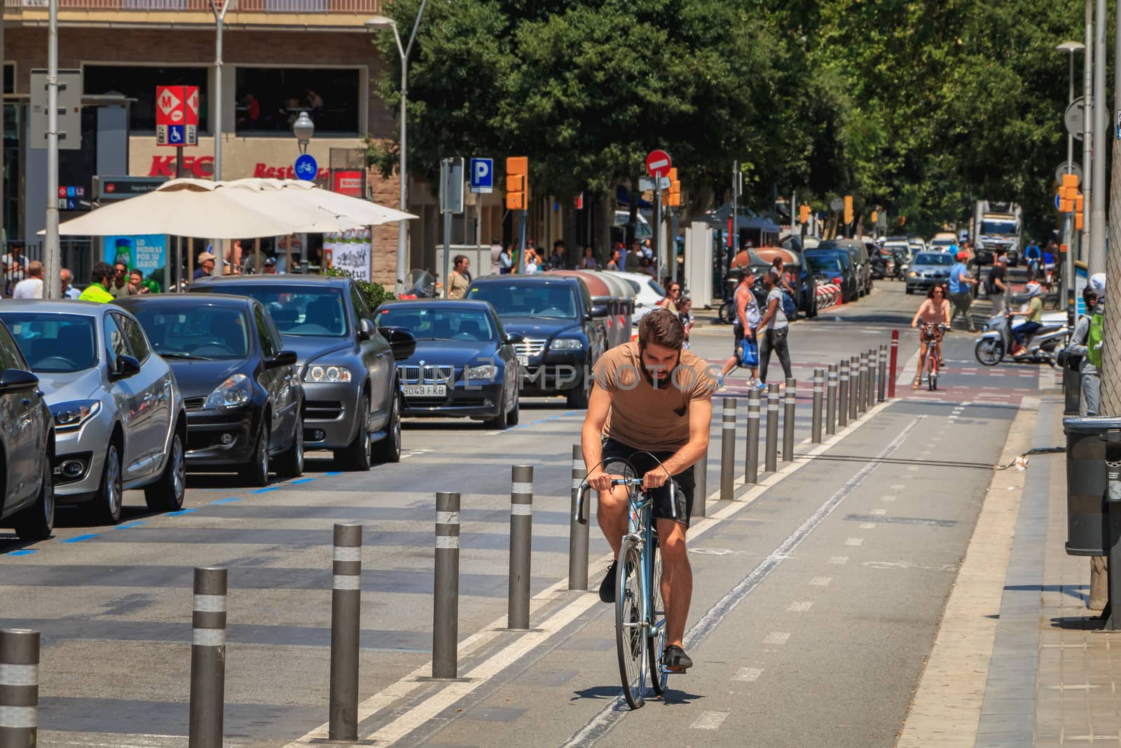 cyclist riding on a bike lane on a summer day by AtlanticEUROSTOXX