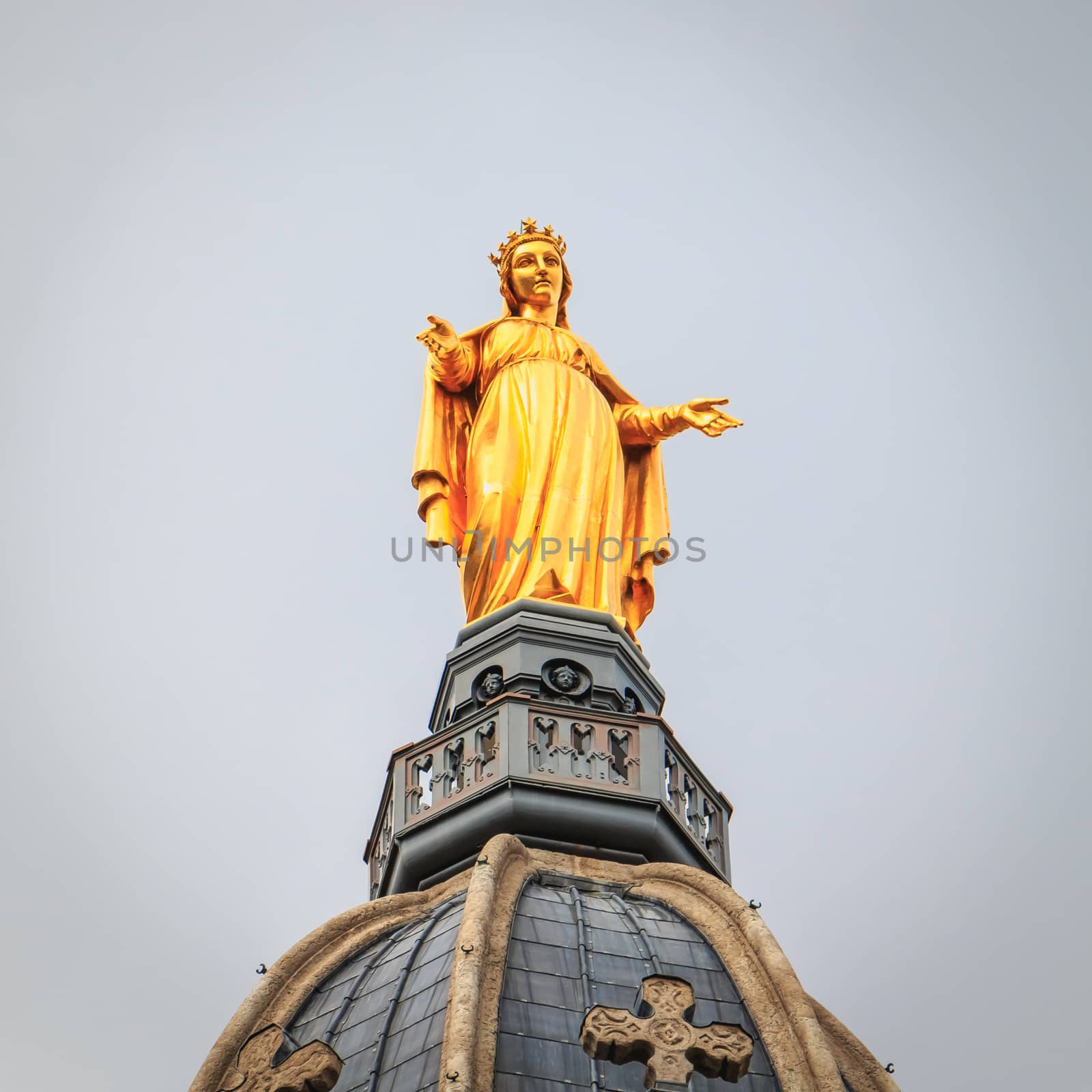 statue of Mary made in 1852 by Joseph-Hugues Fabisch and placed above the belfry of the basilica of Notre Dame de Fourviere in Lyon, France