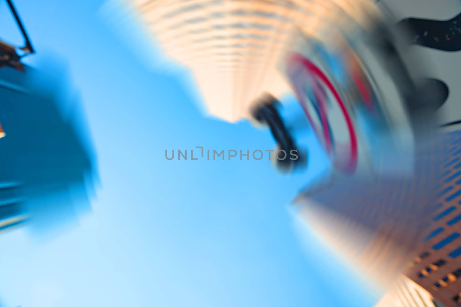 High-rise buildings towering overhead in blurred abstract backgr by brians101