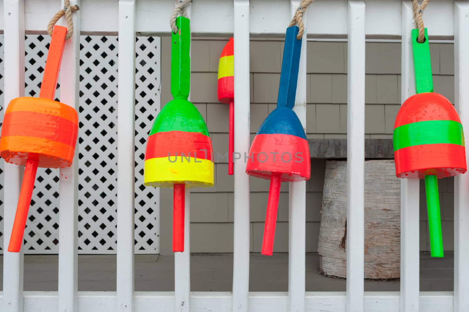 Brightly colored floats hanging on wall in fishing village. of Rye Harbor, Massachusetts.