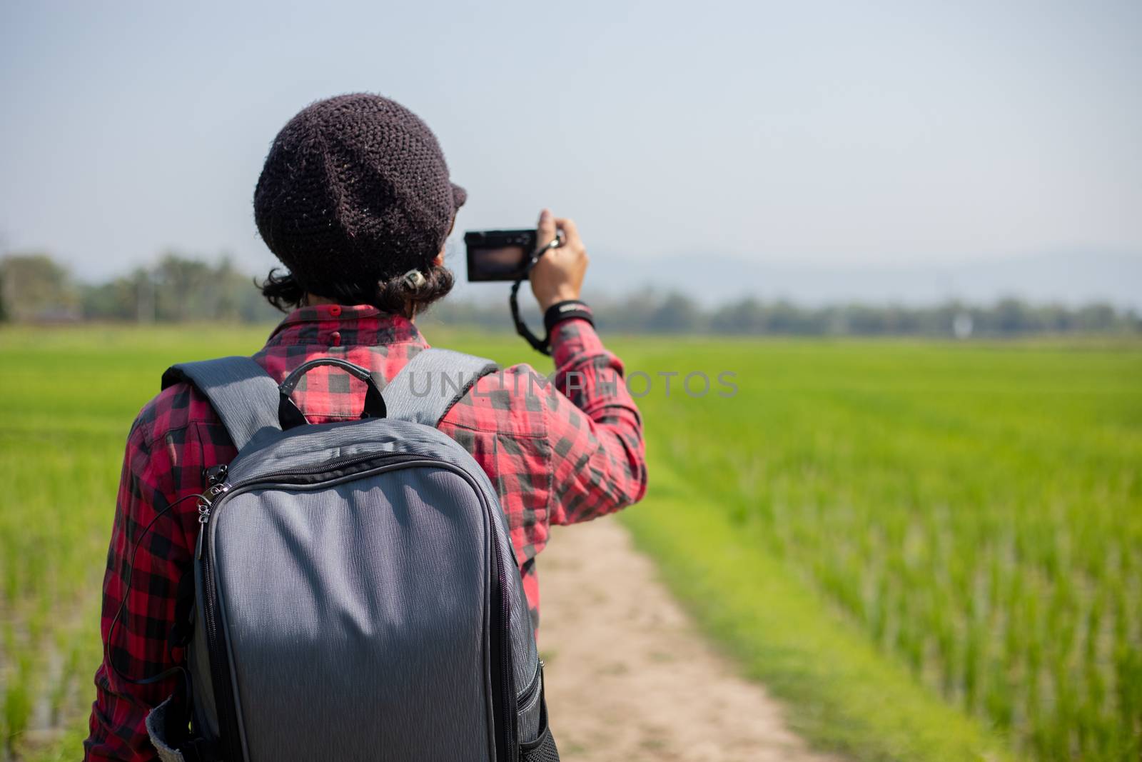 Asian man tourist is using a camera for taking pictures of scenery and mountain .Relax time on holiday concept travel