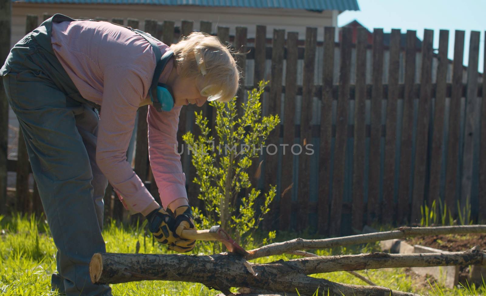 Mature woman chopping with ax by Alize