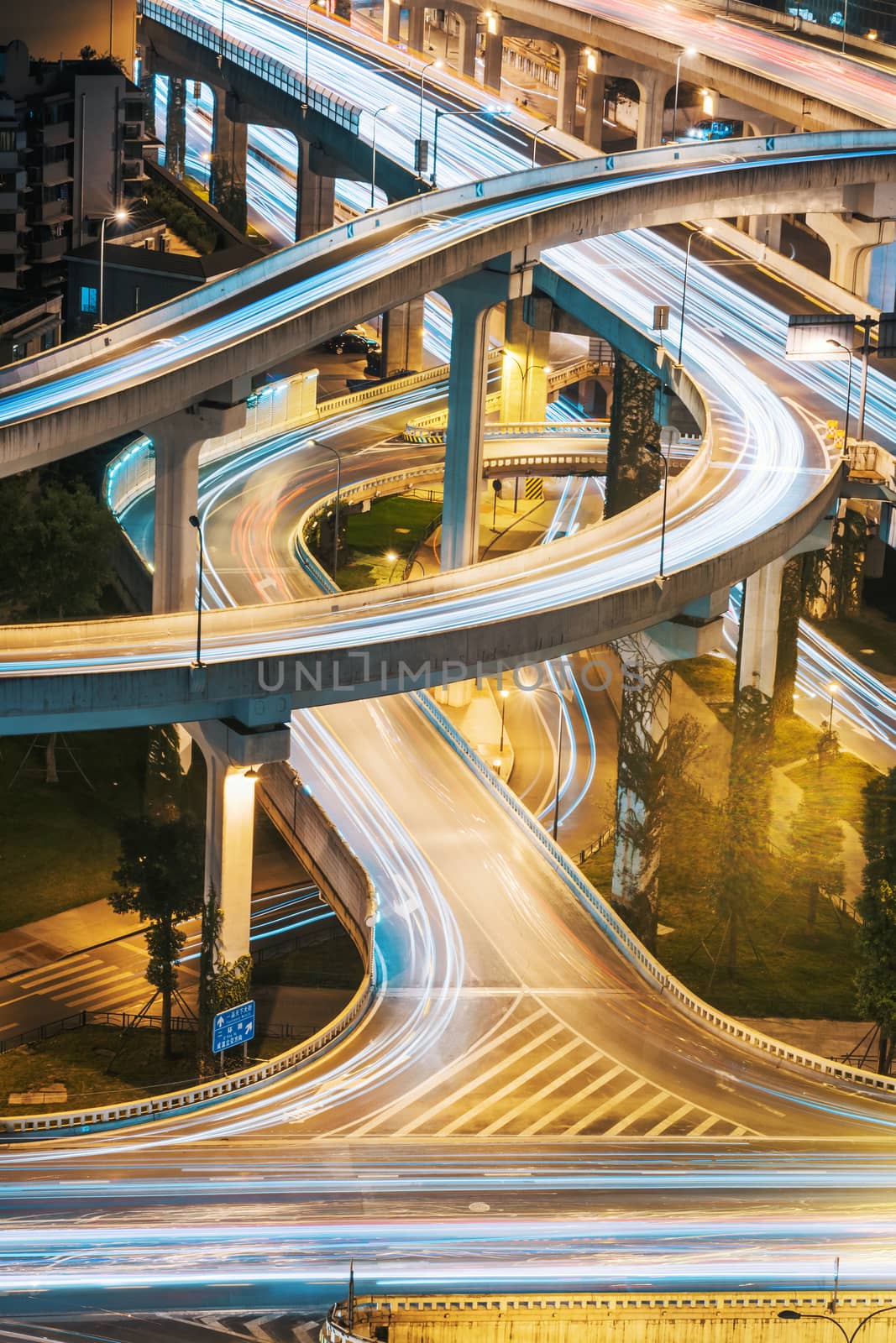 Urban elevated road junction and interchange overpass at night in Chengdu, China