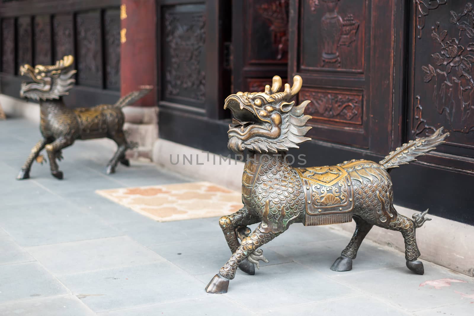 Bronze dragon statues at the entry of a buddhist temple in Chengdu, China