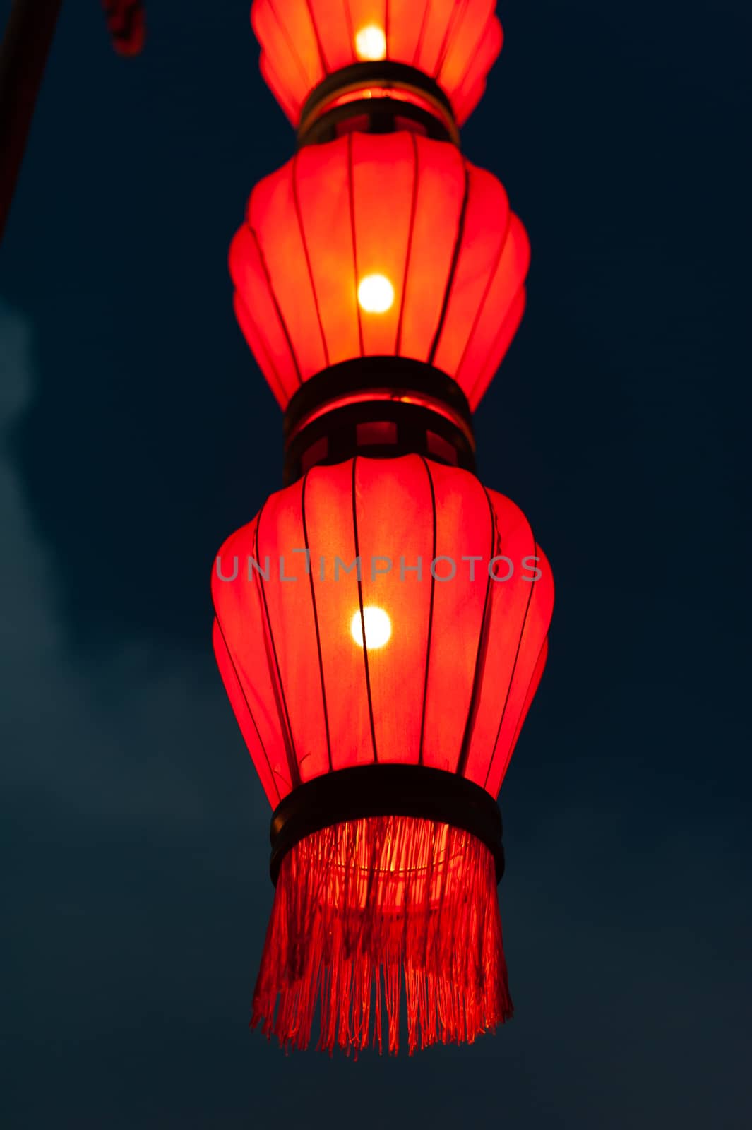 Illuminated red chinese lanterns on the fortified wall at night in Xi'an, China