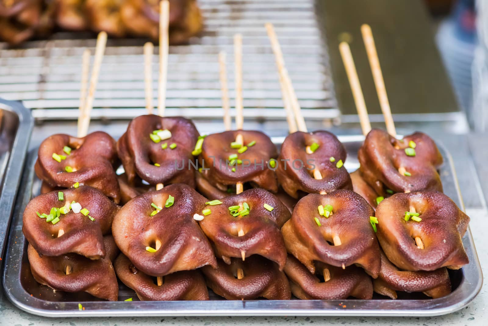 Pig grilled snouts skewers in a street market in China