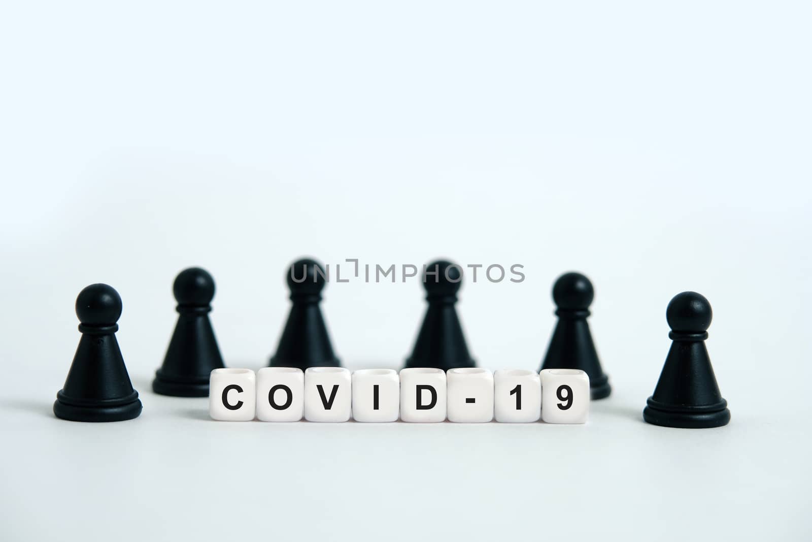Pandemic coronavirus conceptual photography – stop spreading of COVID19 - word beads surrounded by chess pieces. Image Photo