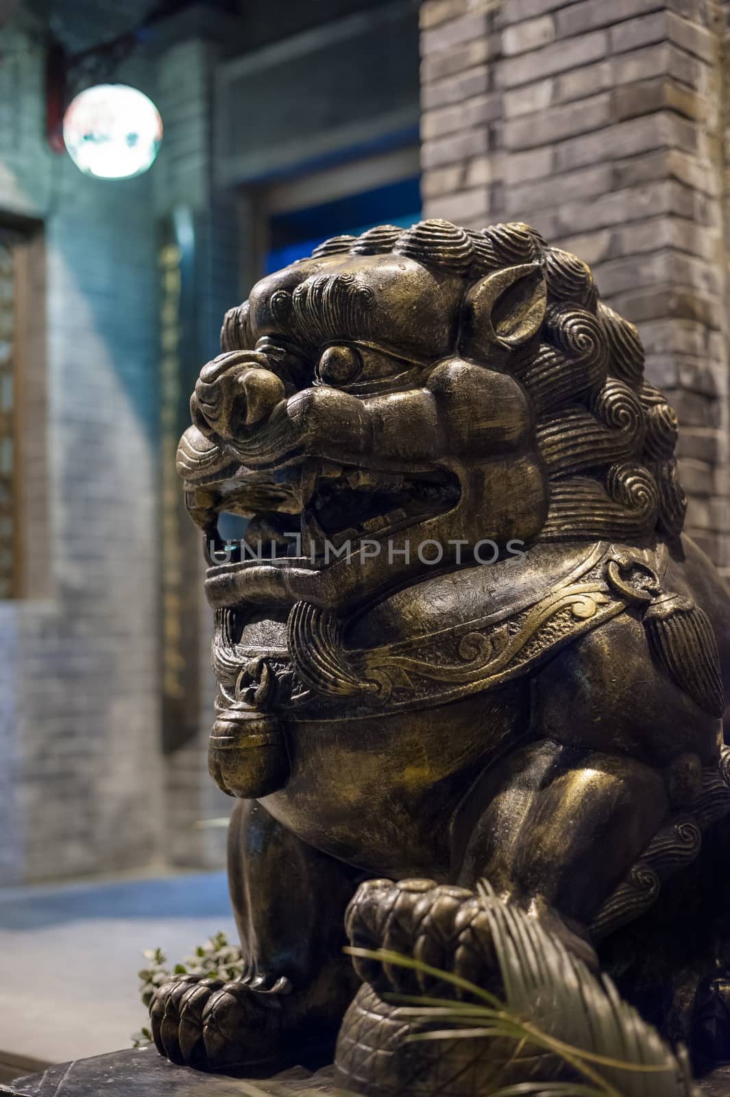 Lion bronze statue at night in a chinese street in Chengdu, China