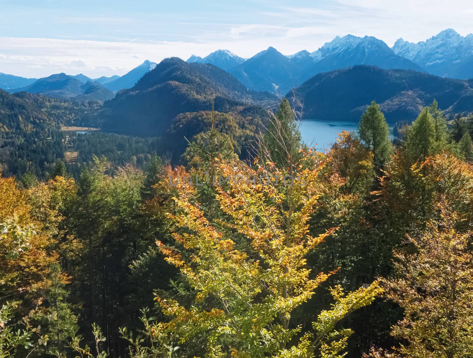 Beautiful nature of European Alps, landscape view of alpine mountains, lake and village on a sunny day, travel and destination scenery