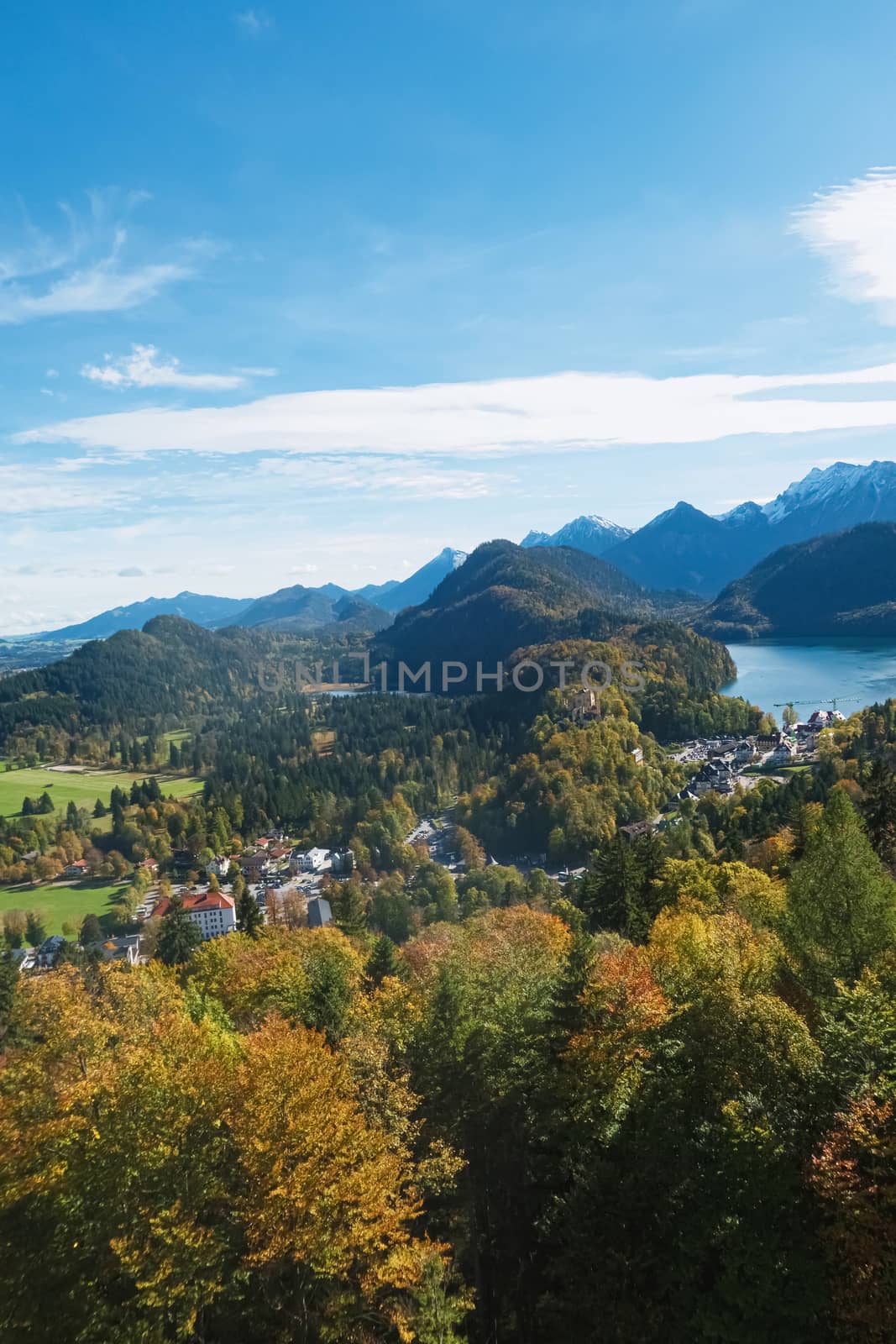 Beautiful nature of European Alps, landscape view of alpine mountains, lake and village on a sunny day, travel and destination scenery