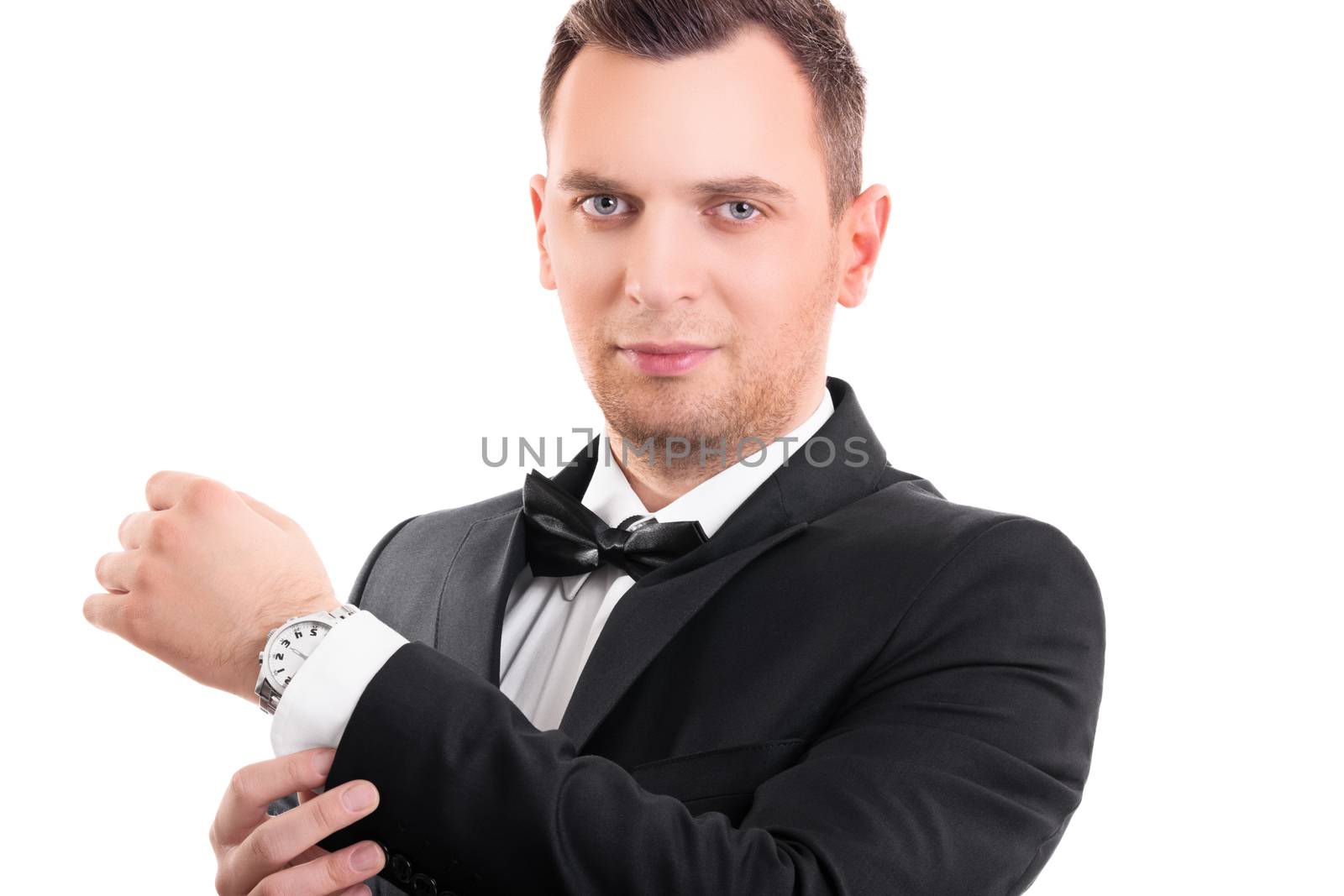 Attractive man in suit adjusting his cufflinks  by Mendelex