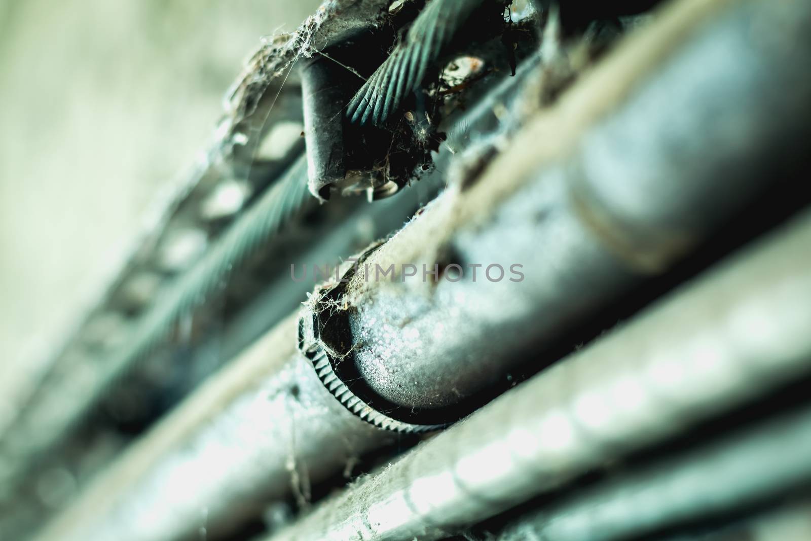 very dirty electrical cables along a dark concrete wall