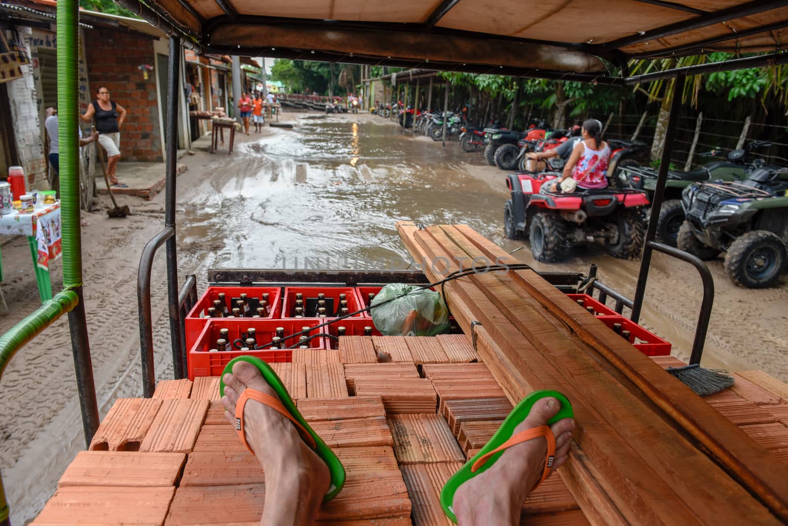 Man traveling sitting on the load of a truck at Barreirinhas on by Fotoember