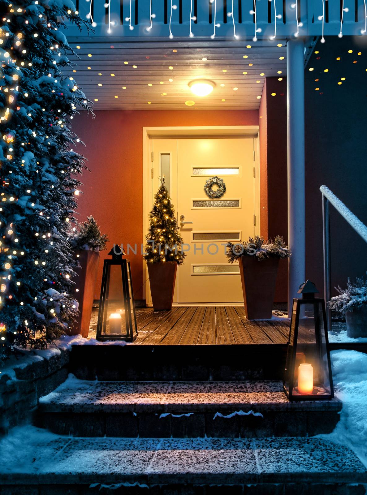 Welcome Christmas - house entrance snowy steps and door with decoration and festive lights
