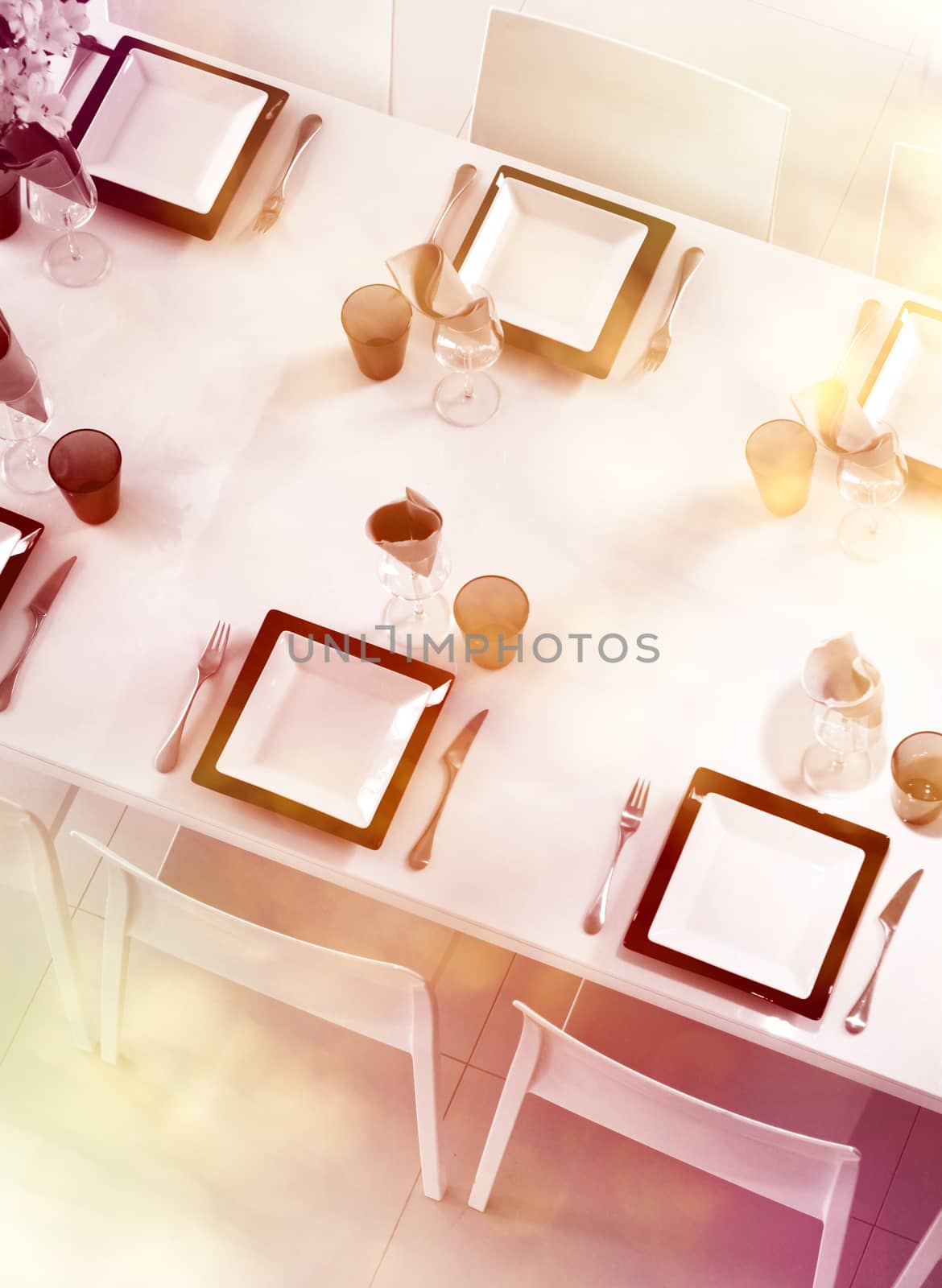Modern black and white dining table setting seen above with pastel colors