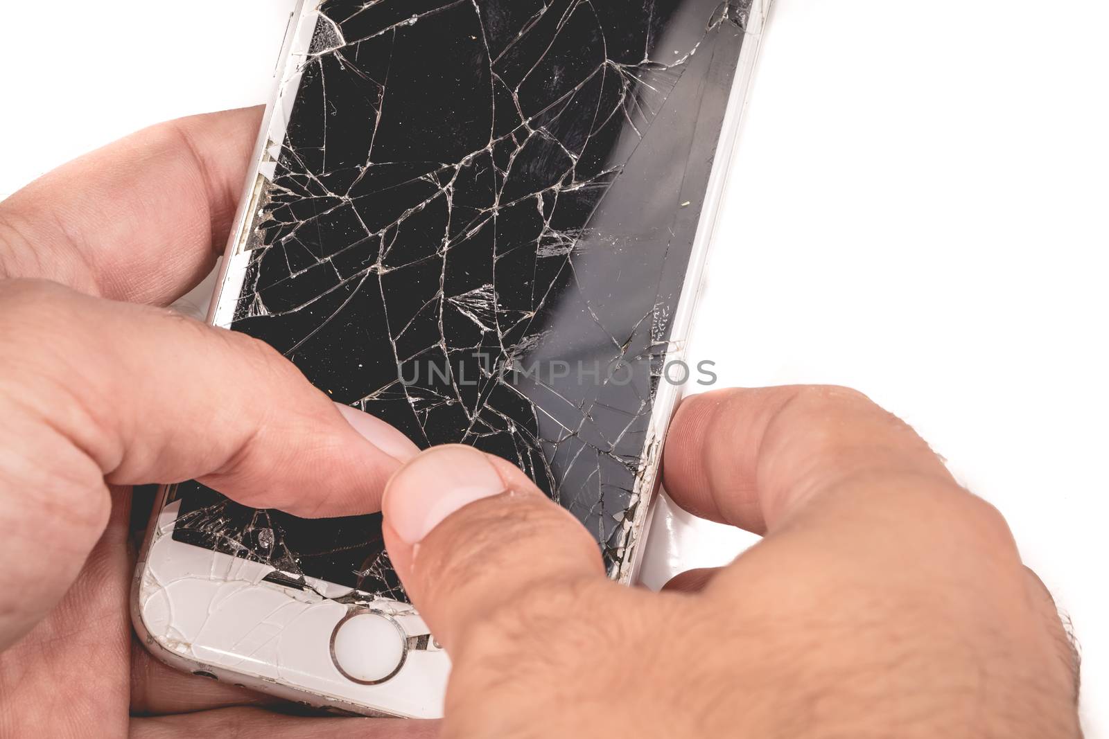 Paris, FRANCE - August 26, 2017: A man holds in his hand an iphone 6S of Apple Inc. whose screen is broken as a result of a violent fall