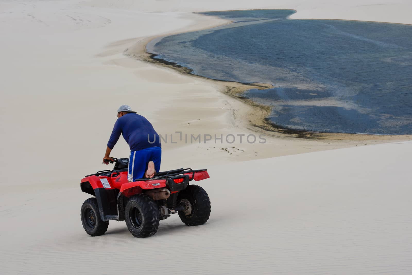 Atins, Brazil - 12 January 2019: man driving his quad on the dunes at Lencois Maranhenese National Park in Brazil