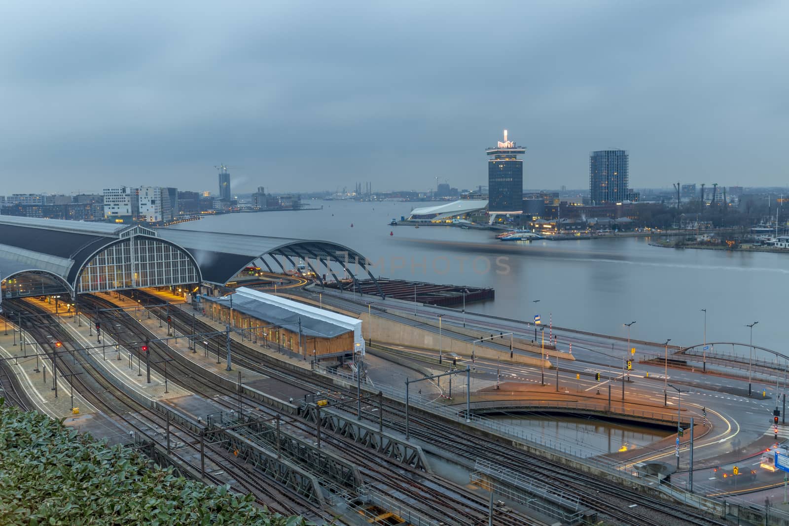 Aerial view of the train station at the edge of the big river in the late evening dull and rainy sky by ankorlight