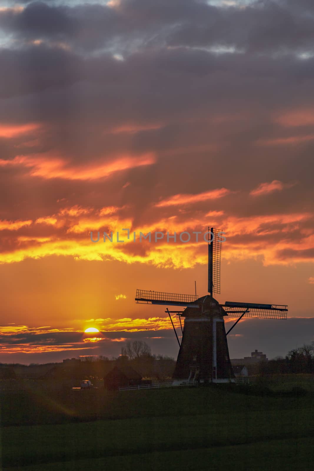 Warm and vibrant sunrise over the Unesco world heritage windmill in Leidschendam, Kinderdijk, Netherlands  by ankorlight