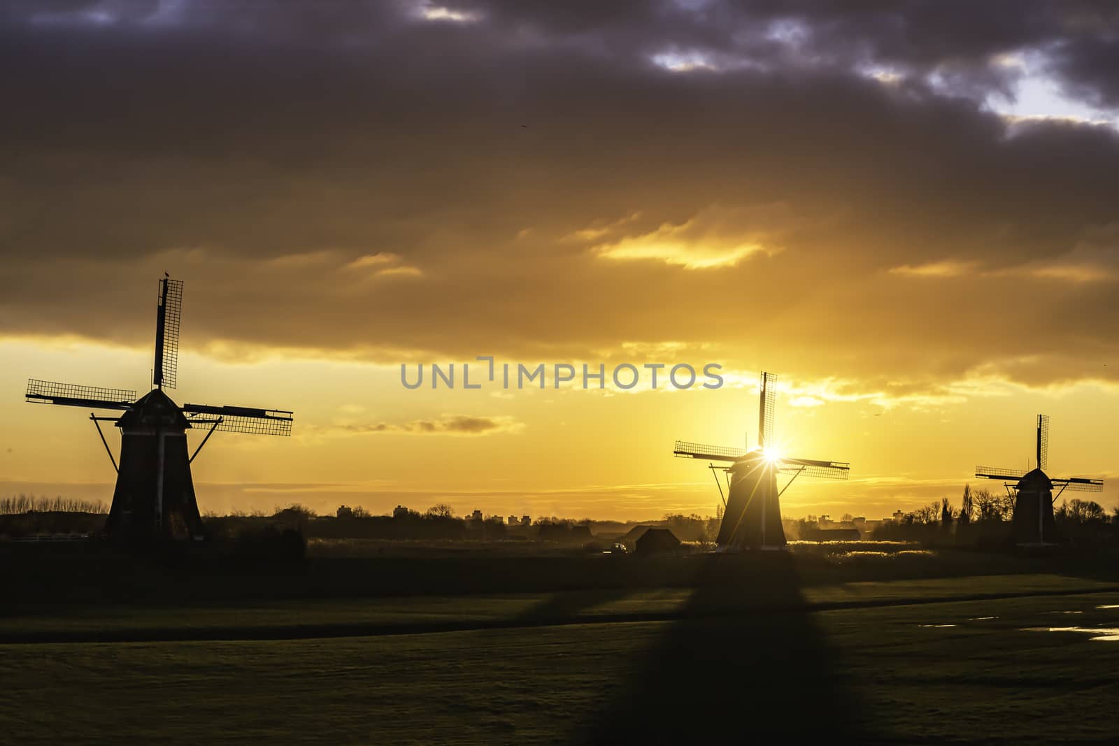 Warm and vibrant sunrise over the Unesco world heritage windmill in Leidschendam, Kinderdijk, Netherlands 