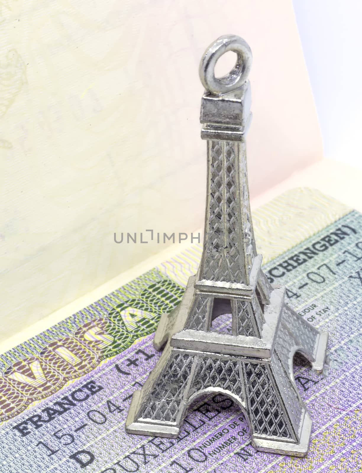 Close up of the Eiffel tower keychain on the Schengen visa allowing the passport holder to travel inside the Schengen treaty territory by ankorlight
