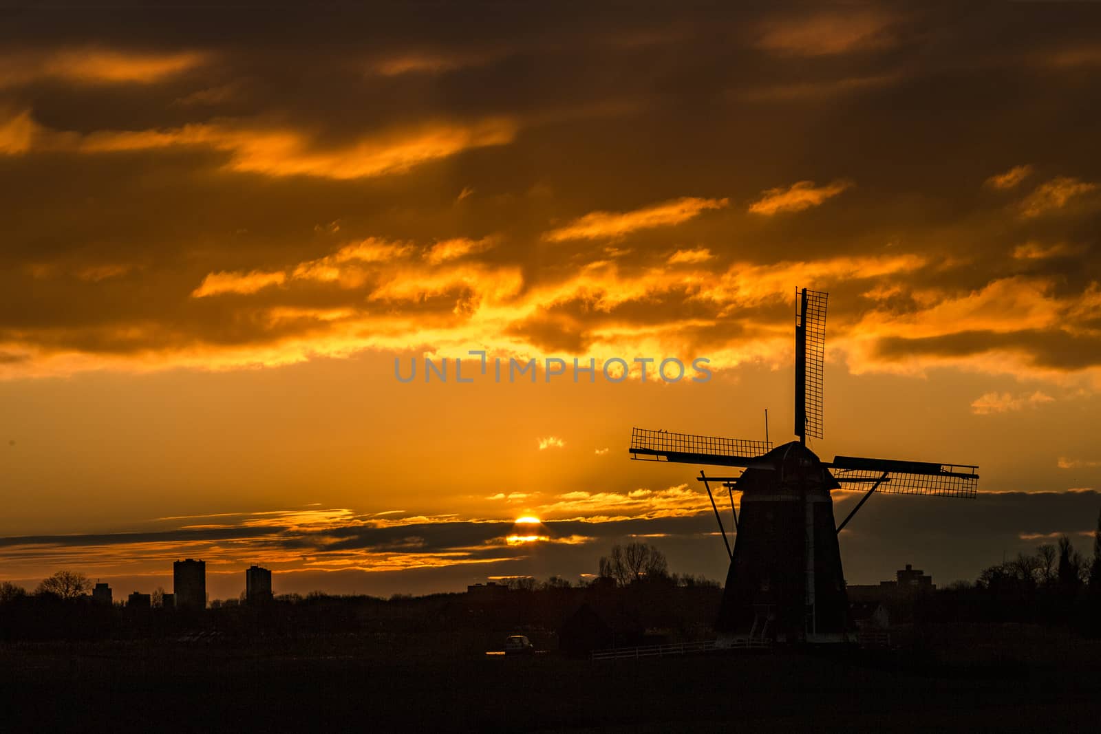 Warm and vibrant sunrise over the Unesco world heritage windmill in Leidschendam, Kinderdijk, Netherlands 