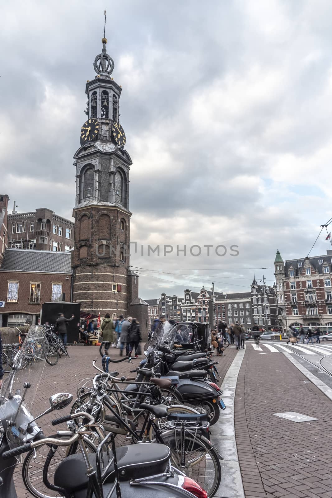 AMSTERDAM, 31 March 2018 - View of the originally part of the Amsterdam wall. This  tower (Munttoren in Dutch) was rebuilt in 1620 & features a carillon with bells. by ankorlight