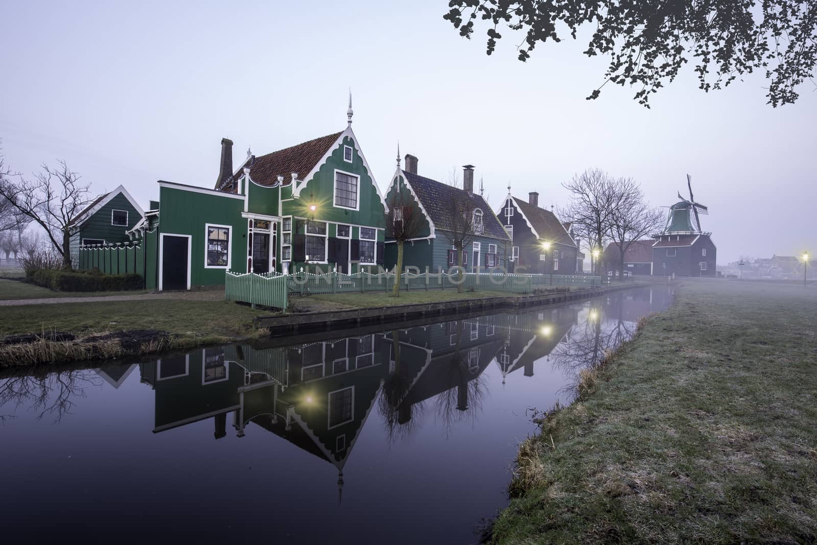 Beaucoutif typical Dutch wooden houses architecture mirrored on the calm canal of Zaanse Schans located at the North of Amsterdam, Netherlands