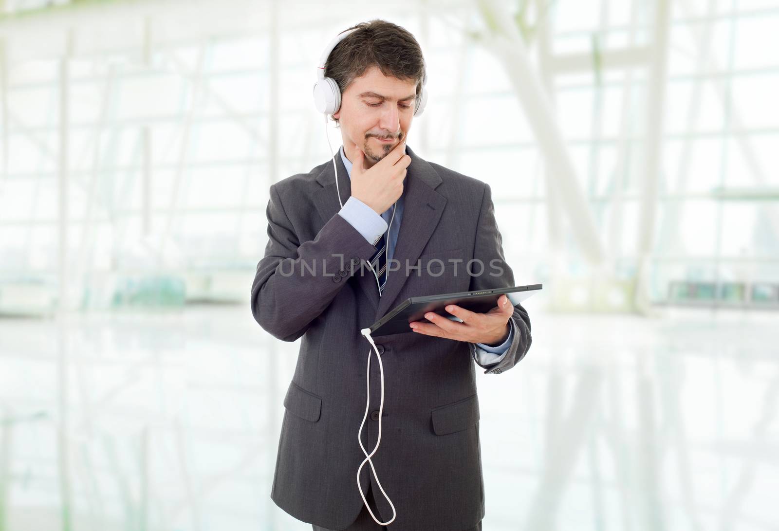 businessman with tablet pc and headphones, at the office