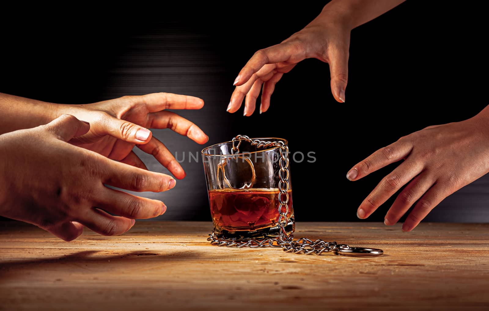 Alcoholism concept . Hands lock chain a glass of whiskey To stop drinking . Stop alcohol addiction . Addicting to alcoholic drink. 