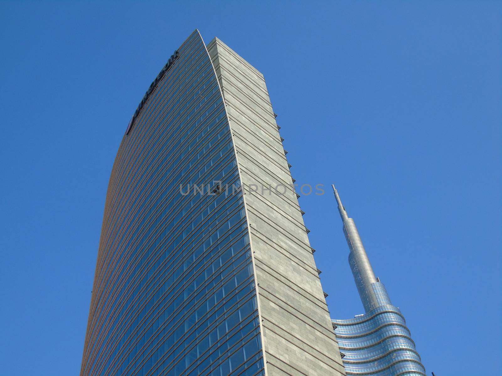 Milano, Italy - 02/14/2020: Amazing photography to the Skyscrapers of Milano in winter days with some people, a great blue sky and some details of the exterior part of the structure