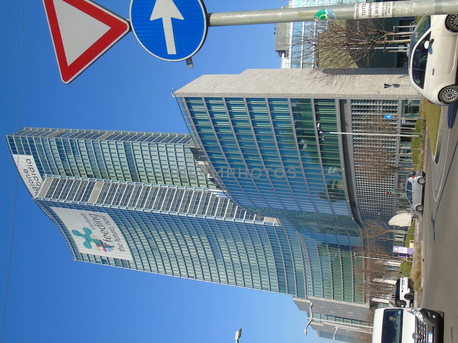 Milano, Italy - 02/14/2020: Amazing photography to the Skyscrapers of Milano in winter days with some people, a great blue sky and some details of the exterior part of the structure