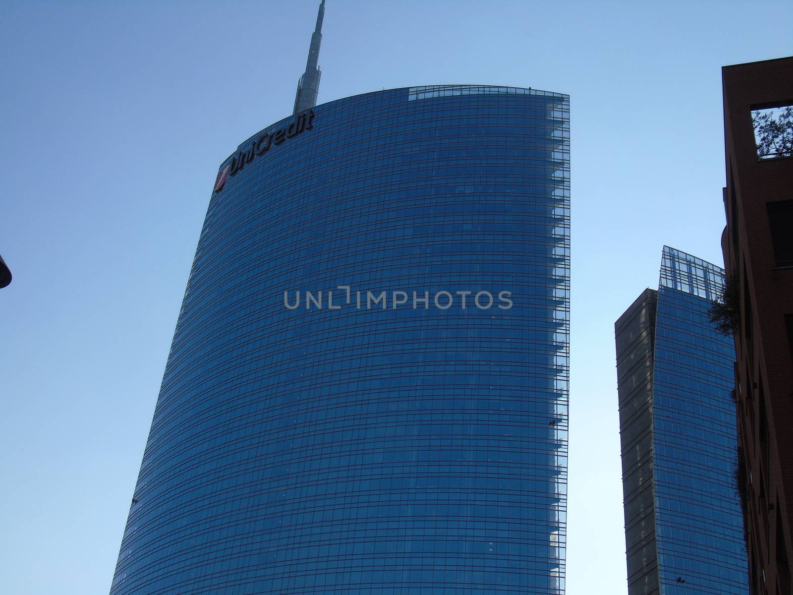 Milano, Italy - 02/14/2020: Amazing photography to the Skyscrapers of Milano in winter days with some people, a great blue sky and some details of the exterior part of the structure