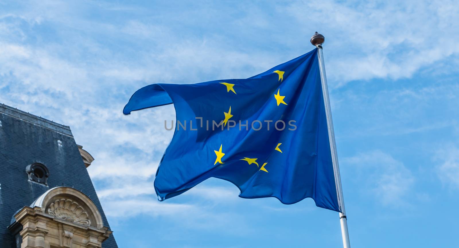 european flags flying in front of a town hall in France