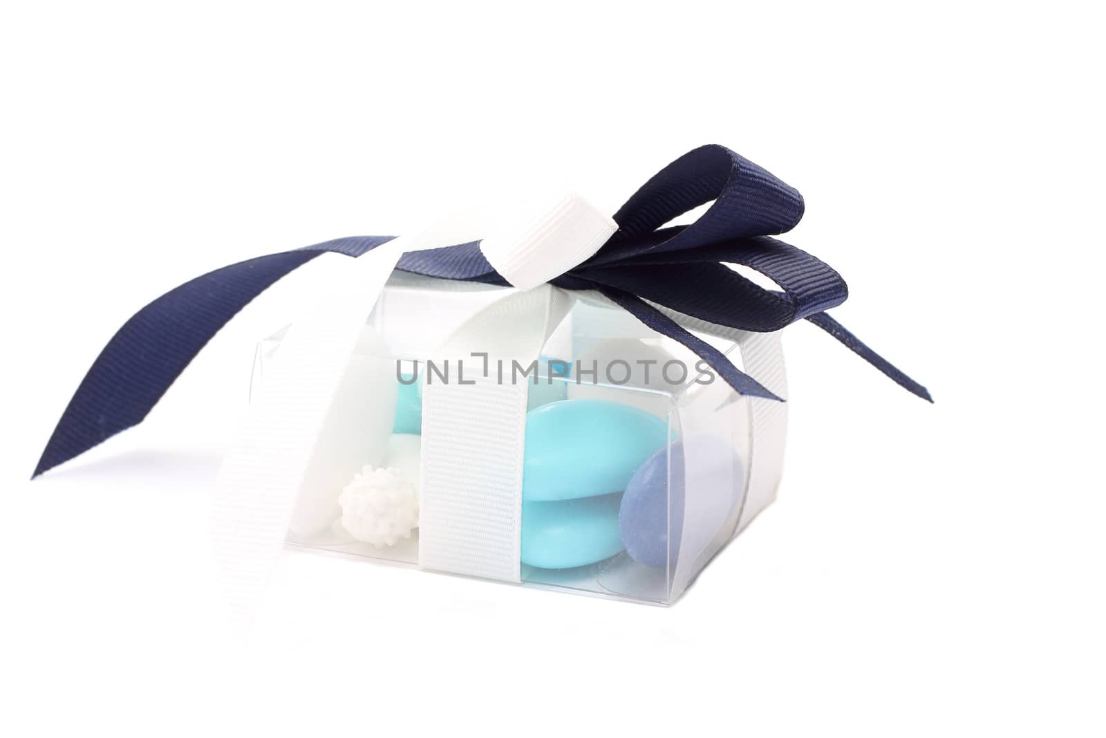 Blue and white sugared almonds in transparent plastic box