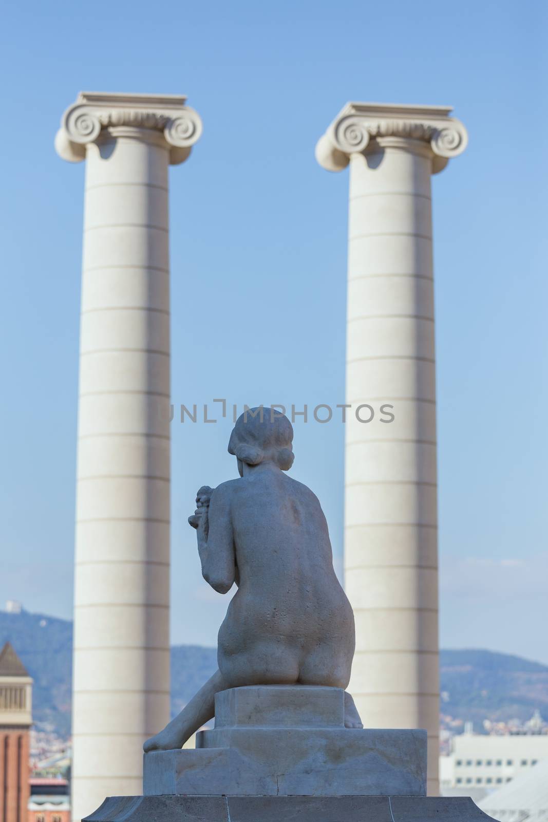 Female statue from the back and The Four Columns ("Les Quatre Columnes" in Catalan), Montjuic Barcelona, Catalunya/Spain ,01 november 2016