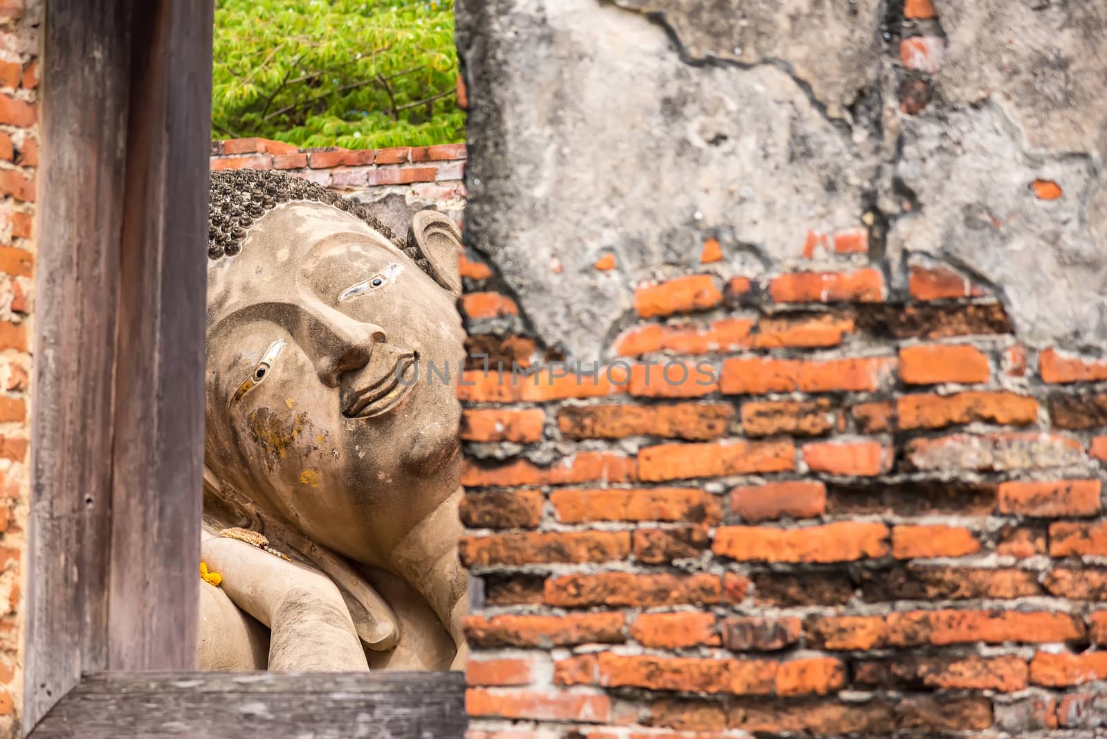 Ayutthaya Thailand June 13, 2020 : Reclining Buddha in the temple,Archaeological site,Pagoda Putthaisawan Temple Ayutthaya , Thailand