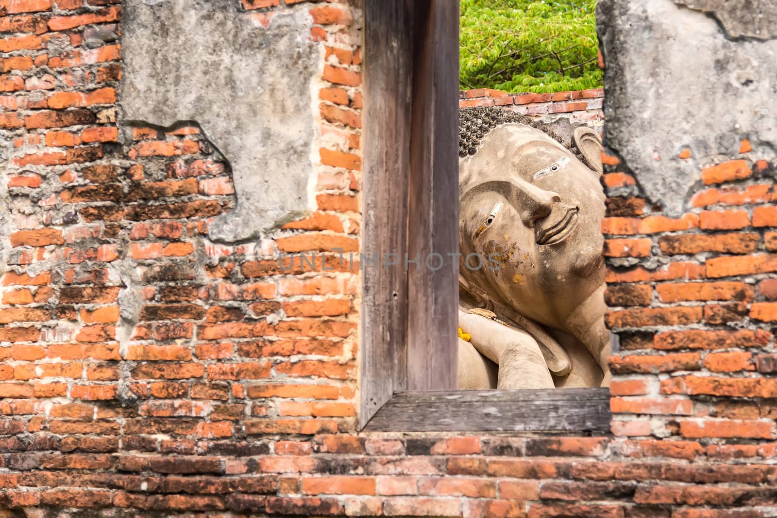 Ayutthaya Thailand June 13, 2020 : Reclining Buddha in the temple,Archaeological site,Pagoda Putthaisawan Temple Ayutthaya , Thailand