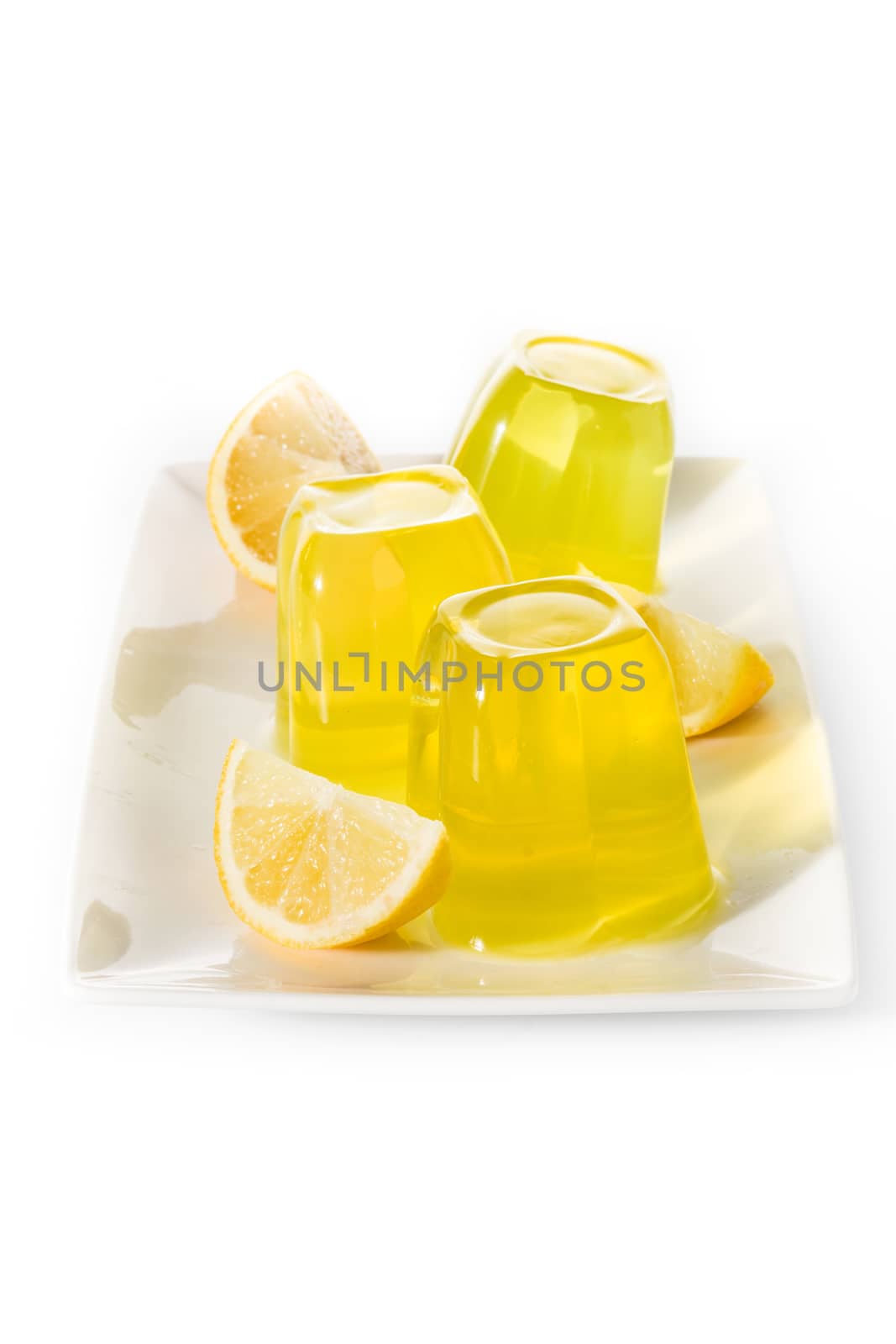 Lemon jellies on a plastic cup isolated on white background.