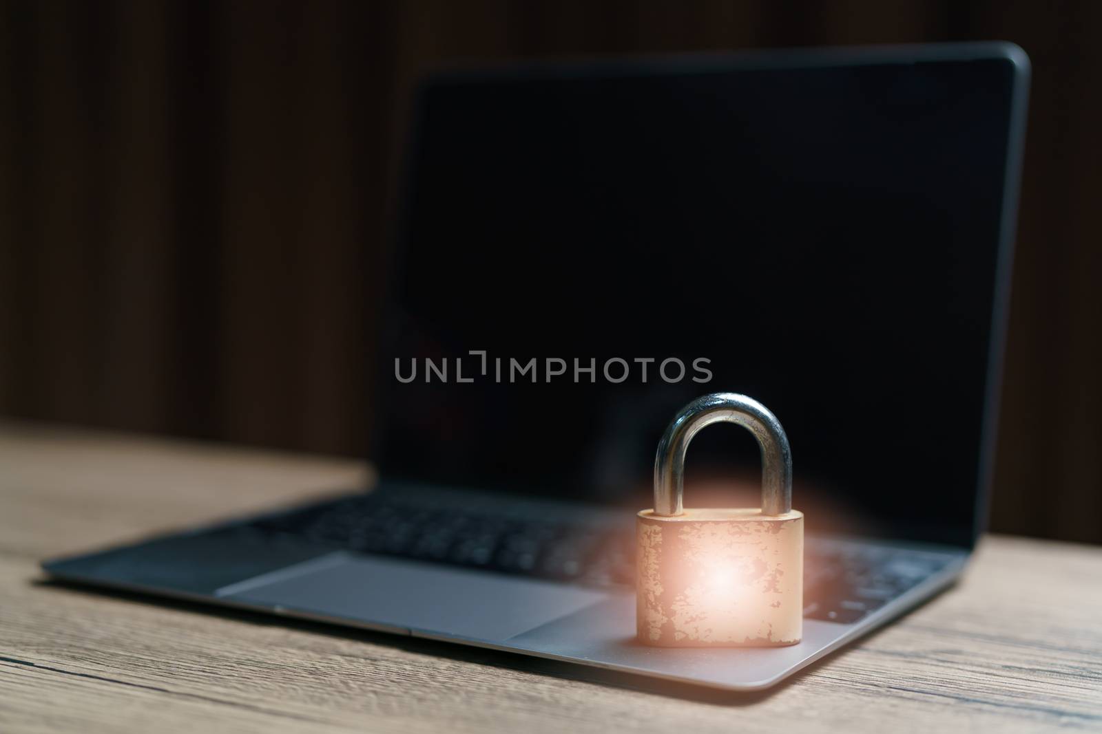 Gold master lock key place on the laptop is concept to lock a datas.