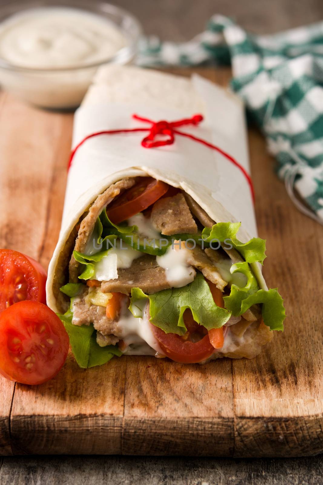 Doner kebab or shawarma sandwich on wooden table