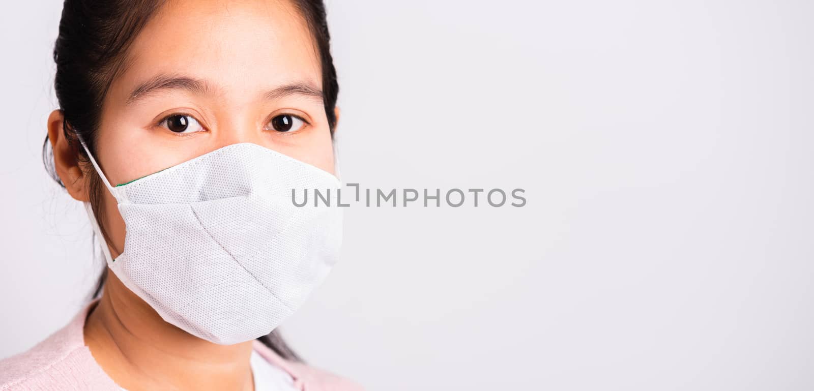 woman wearing protection face mask against coronavirus by Sorapop