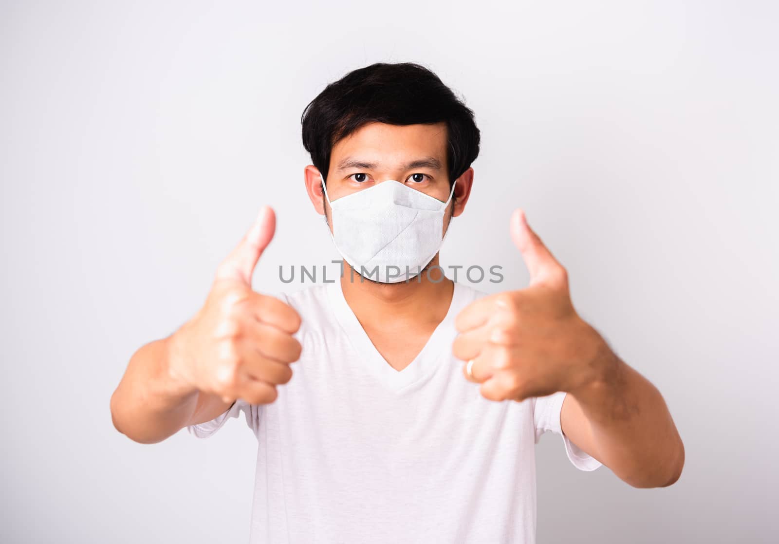 Man wearing surgical hygienic protective cloth face mask against by Sorapop