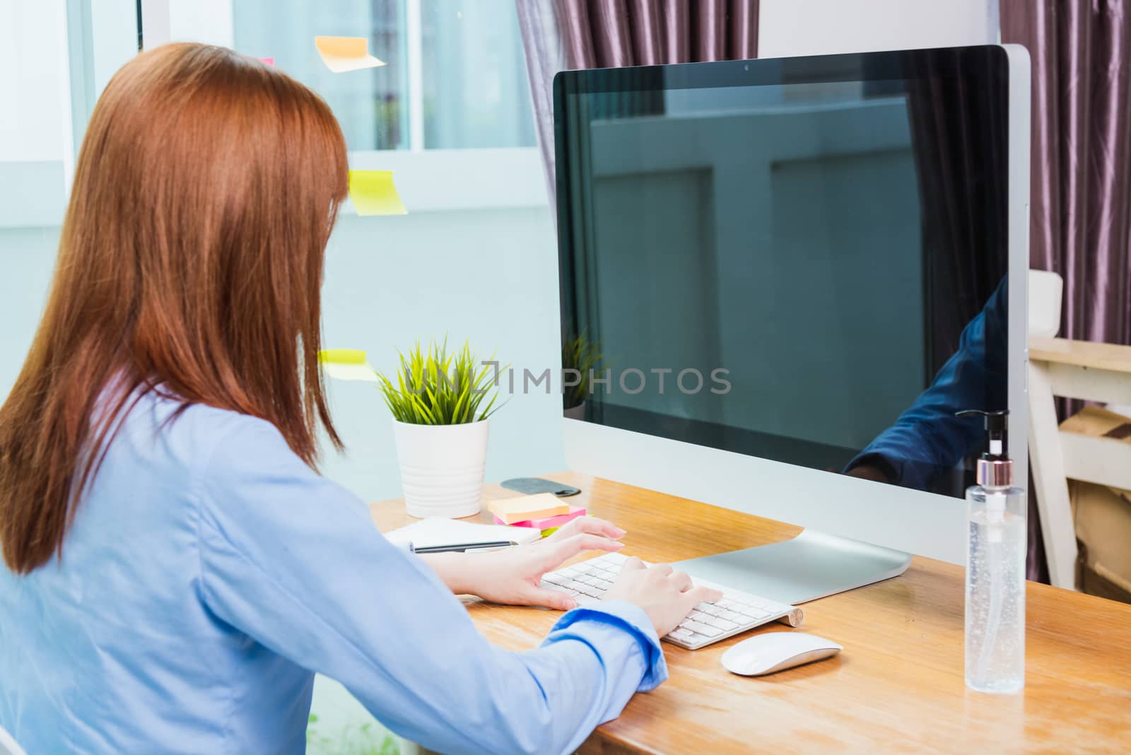 Asian businesswoman wear face mask protective working from home office with desktop computer under quarantines disease coronavirus making video call conference talking online to team consultation