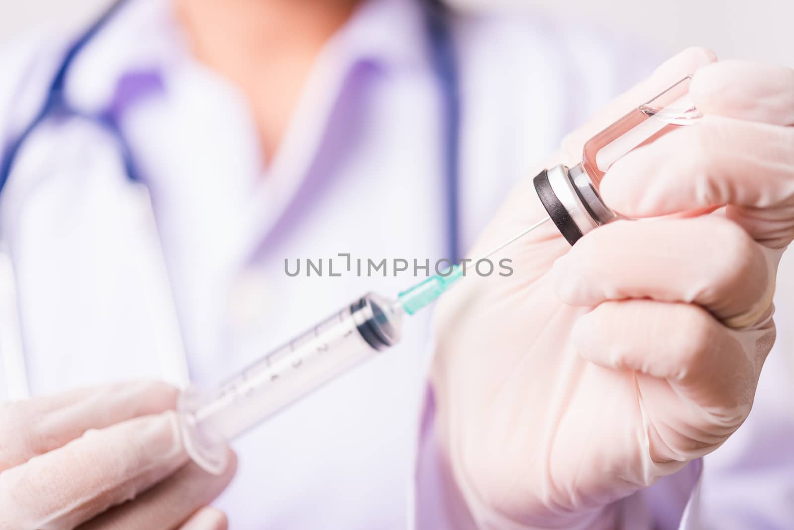 woman doctor or scientist in lab use holding and syringe injecti by Sorapop