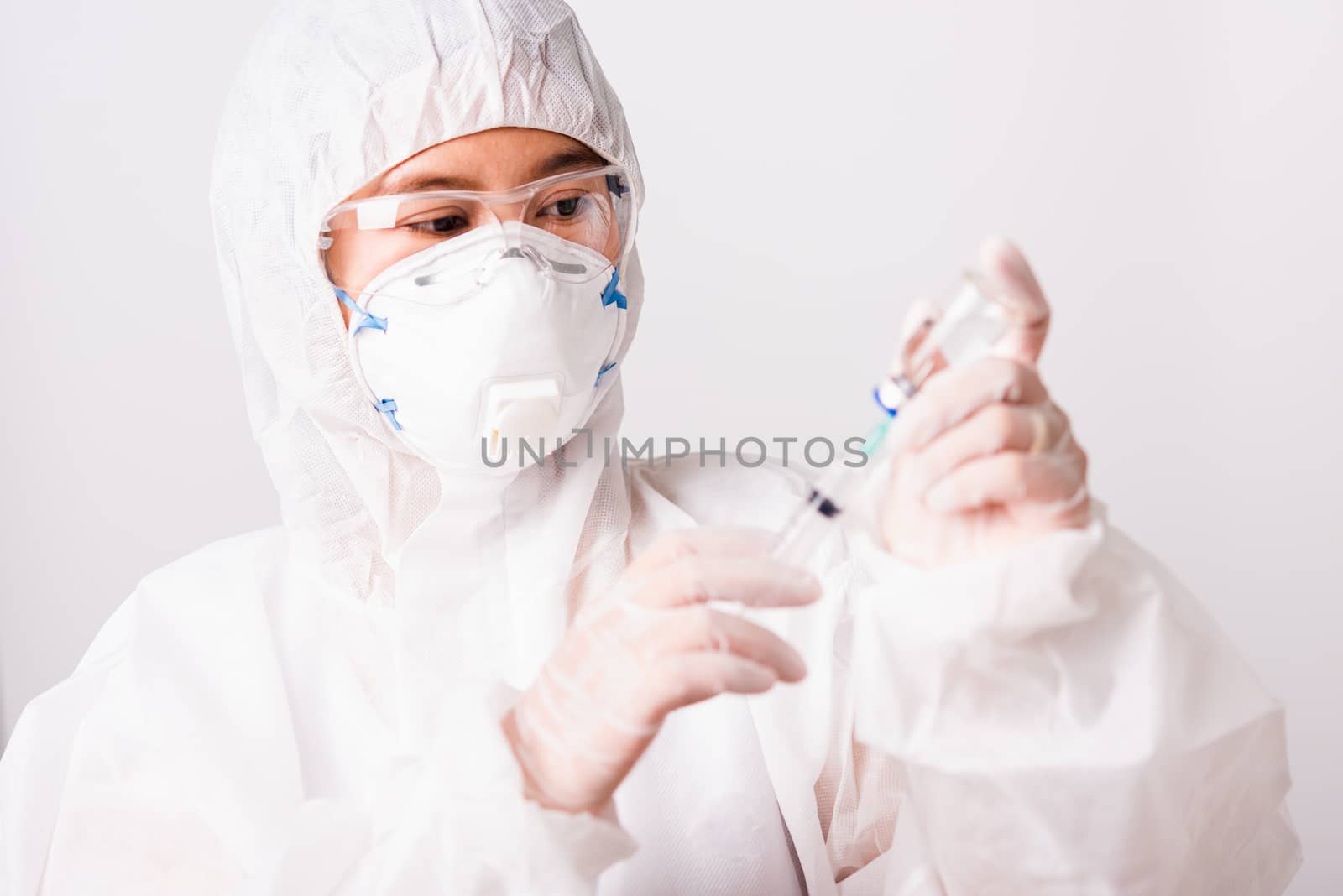 doctor or scientist in PPE suite uniform in lab hold medicine li by Sorapop