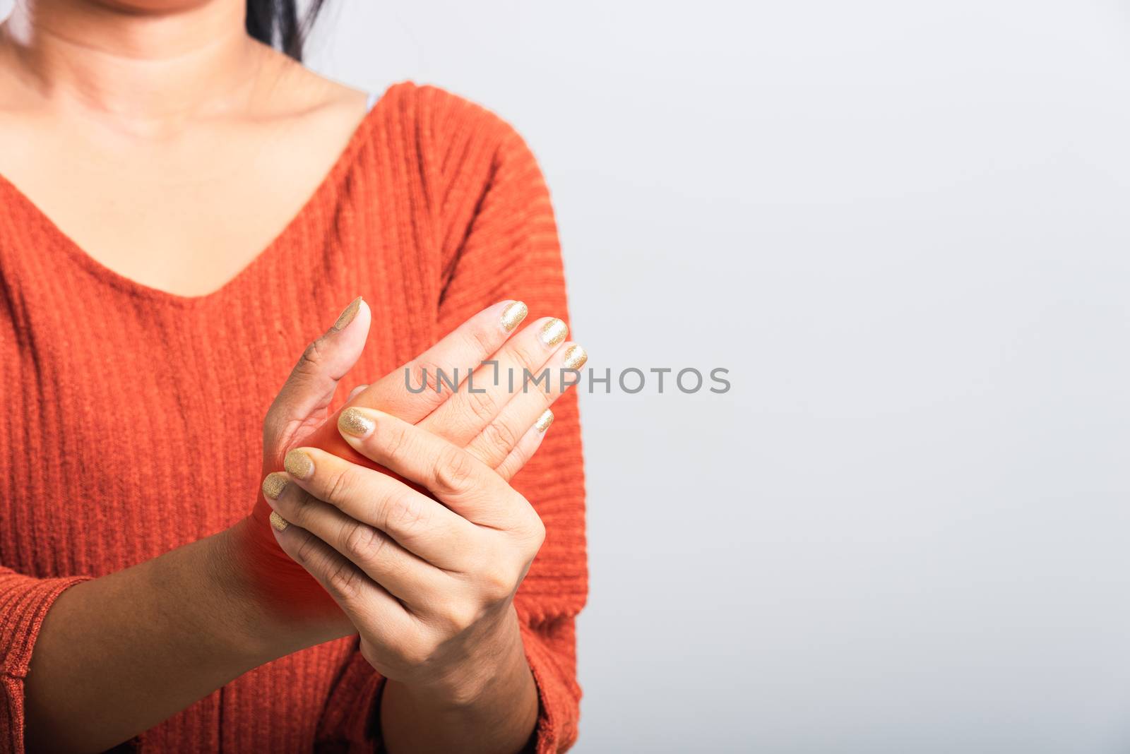 Close up hand of Asian woman she holding her acute pain in wrist of hands, studio shot isolated on white background, Healthcare medicine arthritis body care symptomatic office syndrome concept